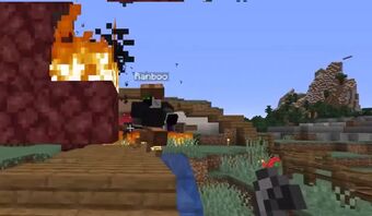 This is a screenshot of Tommy's stream. He's running away backwards from George's house. Ranboo is hot on his trail wearing leather armor dyed black. Tommy holds a flint and steel in his hands, and we can see flames coming up out of the roof of George's house.